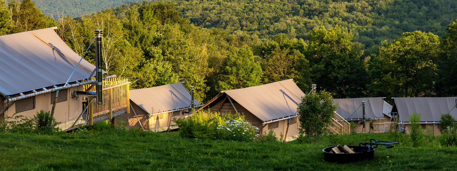 Lush nature and wood and canvas tents