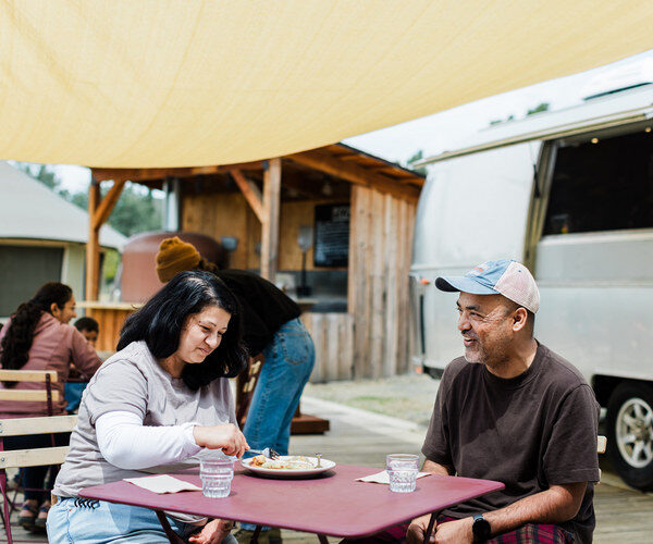 Couple enjoying crepes in front of the airstream kitchen
