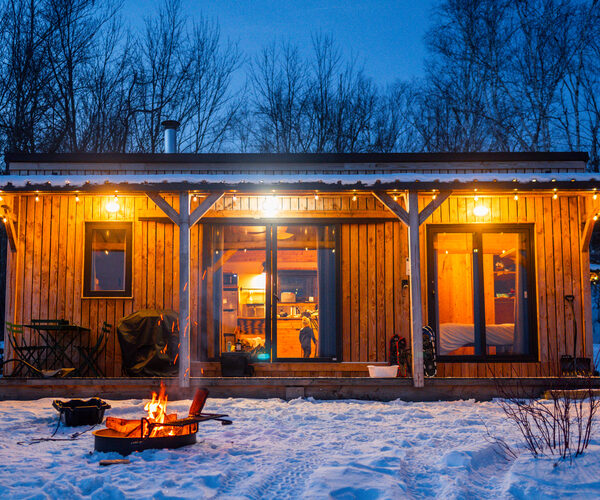 Sierra Tiny House at night with fire pit outside